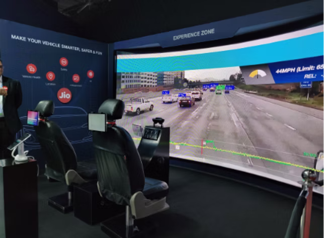 The stall's driving Experience Zone with simulator seating and curved screen
